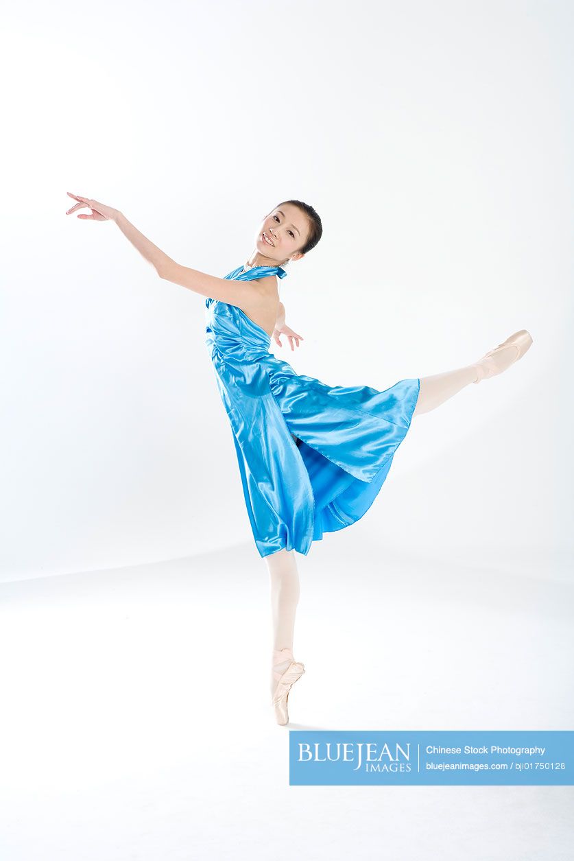 Young Chinese woman dancing in a blue dress