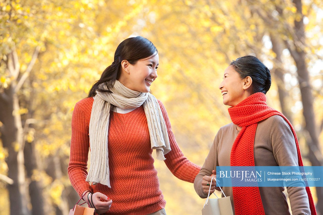 Chinese mother with adult daughter shopping in autumn-High-res stock ...