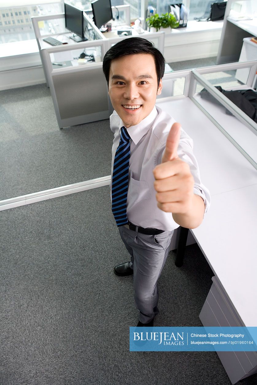Chinese office worker giving thumbs up