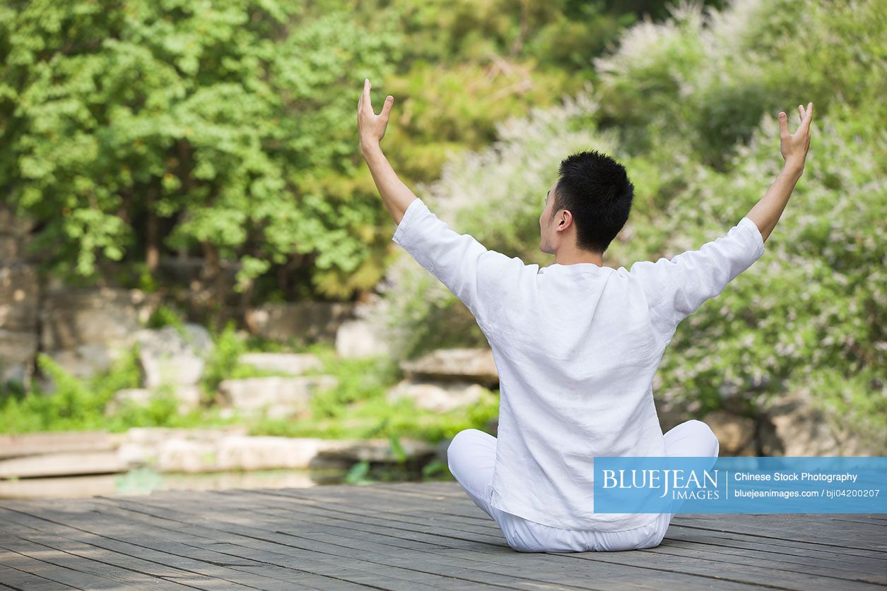 Young Chinese man practicing yoga