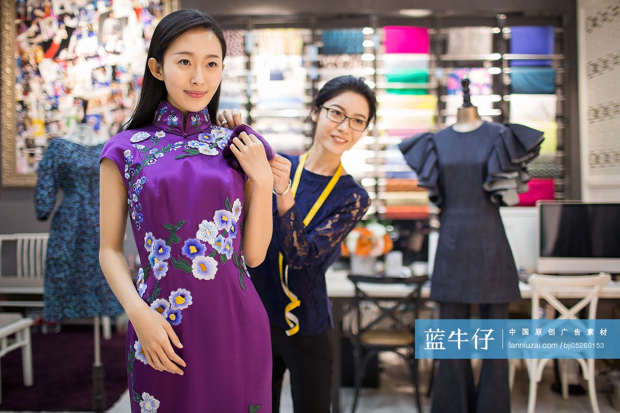 服装设计师帮顾客调整旗袍