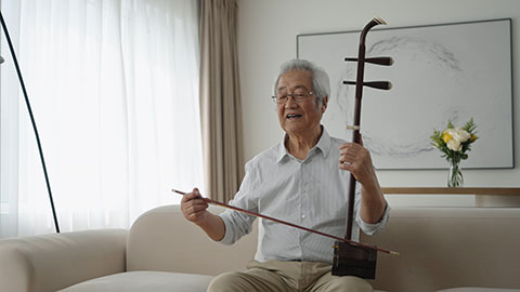 Senior Chinese man playing traditional musical instrument Erhu,4K