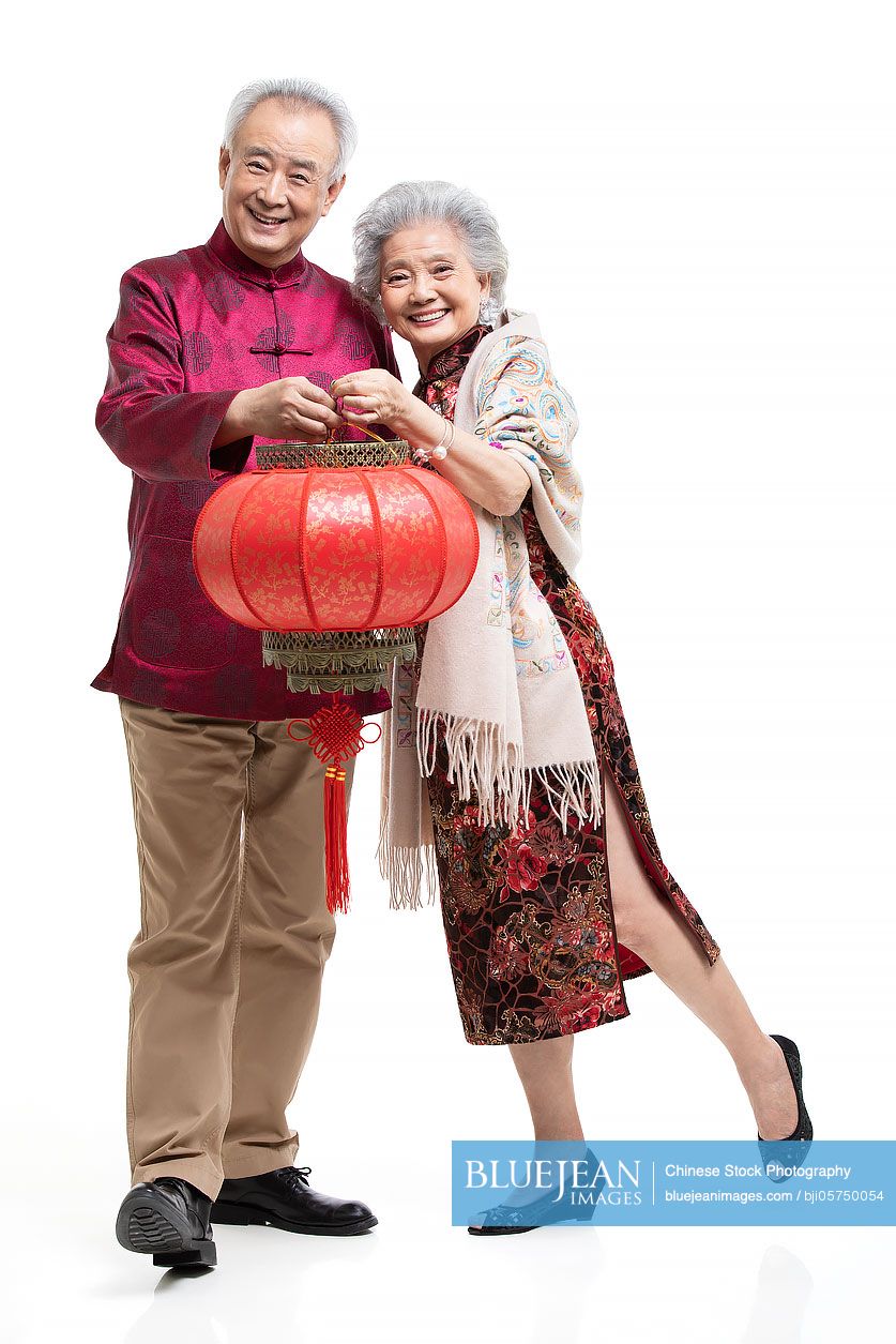 Happy senior Chinese couple celebrating Chinese new year