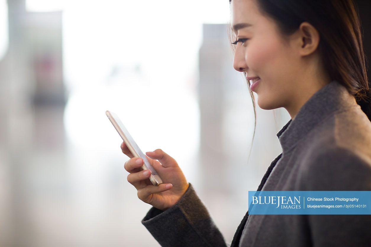 Chinese businesswoman using smart phone