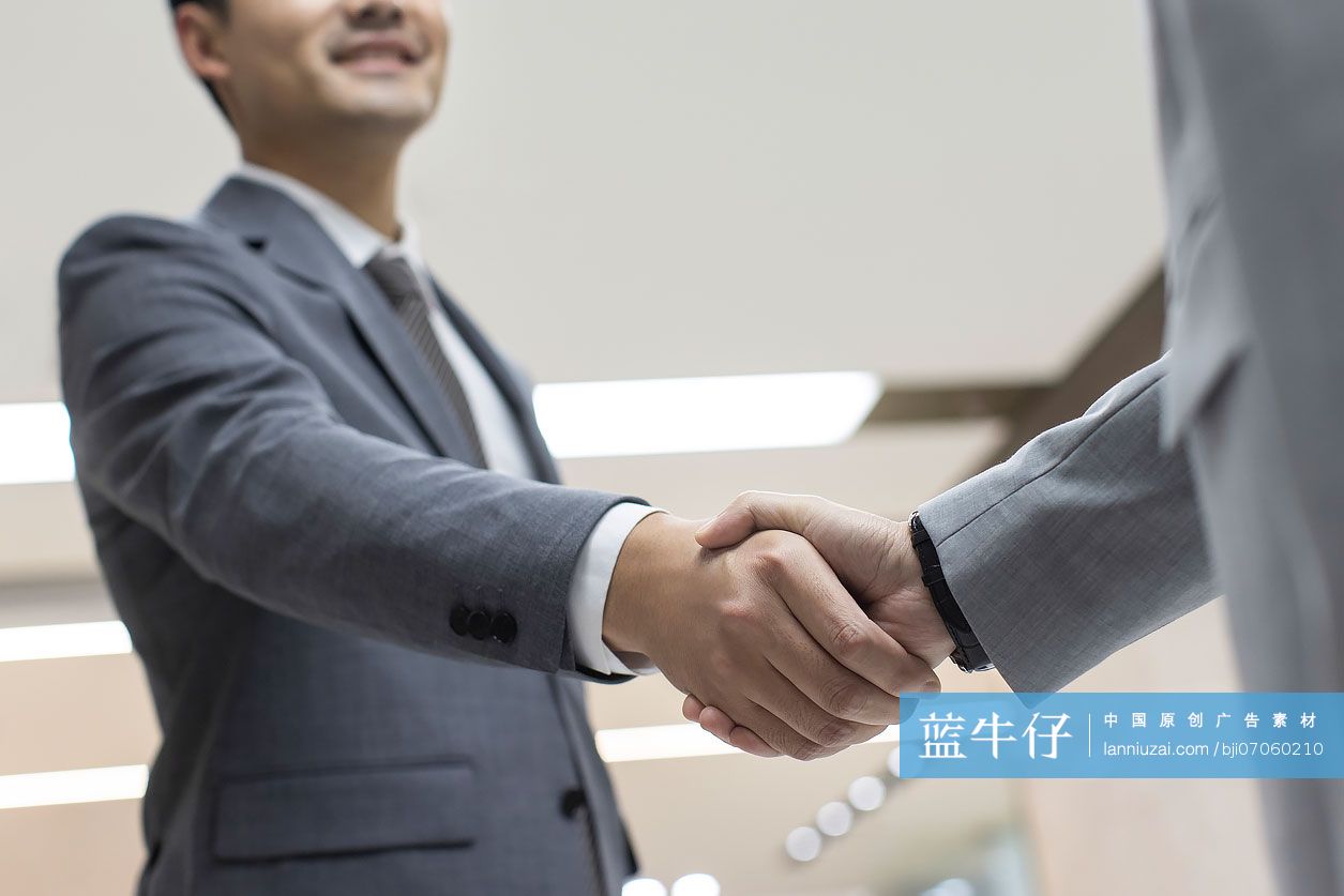 成功商务人士在办公室握手问候