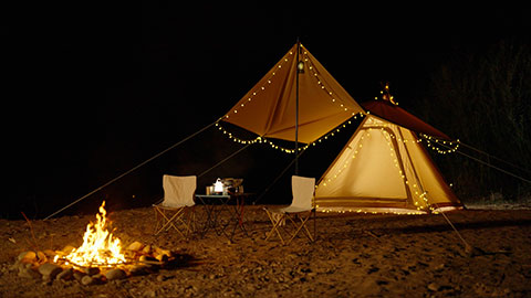 Illuminated tent and campfire