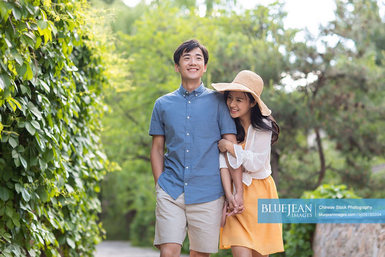 Happy young Chinese couple enjoying vacation