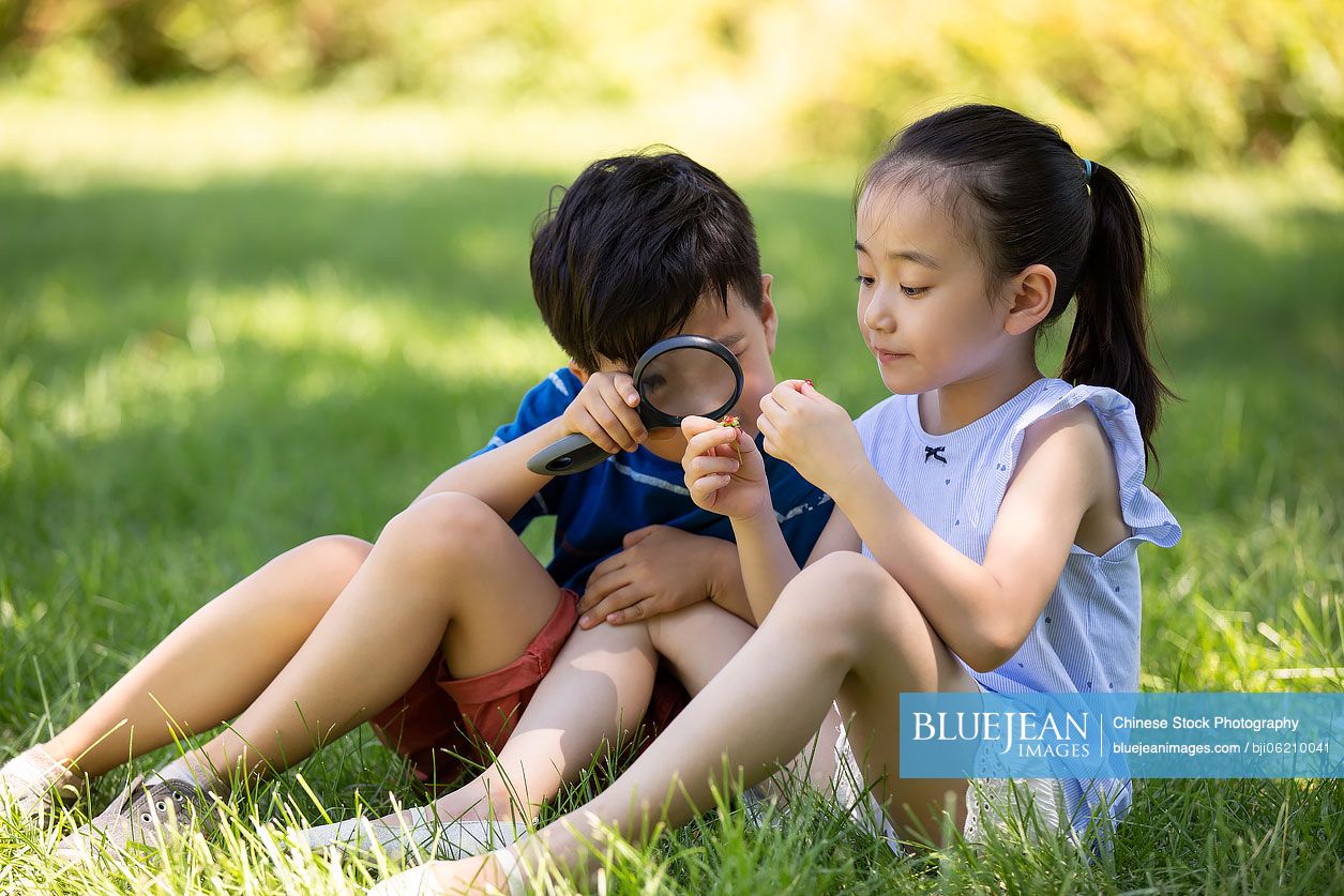 Happy Chinese children playing on meadow