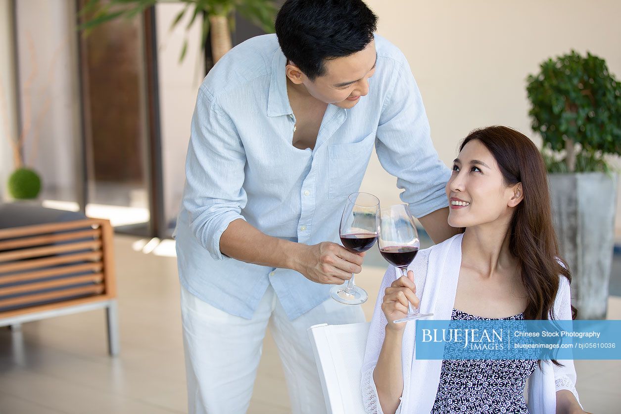 Happy young Chinese couple toasting