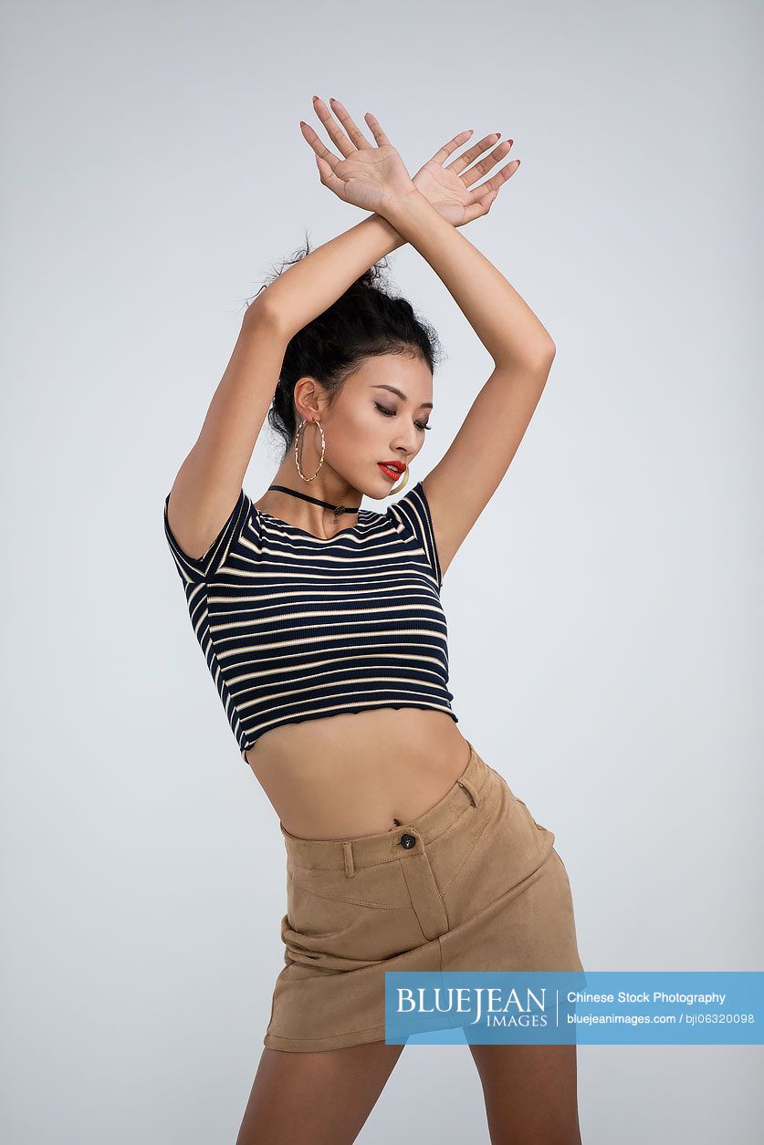 Cool young Chinese woman dancing