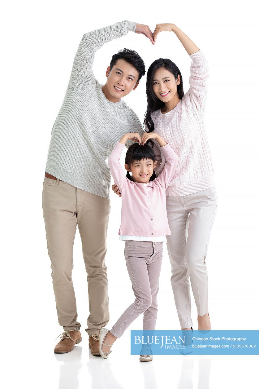 Happy young Chinese family making heart shape