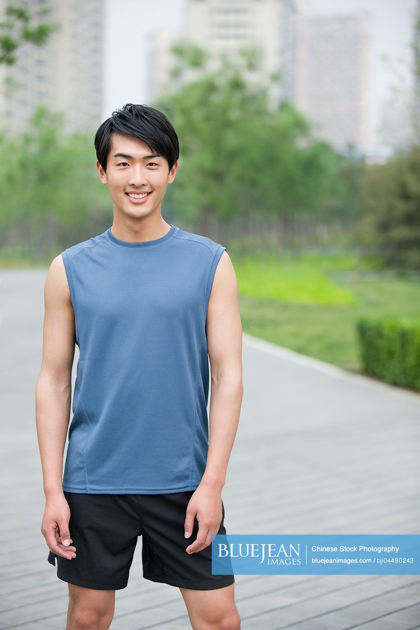 Young Chinese man taking a break from exercise