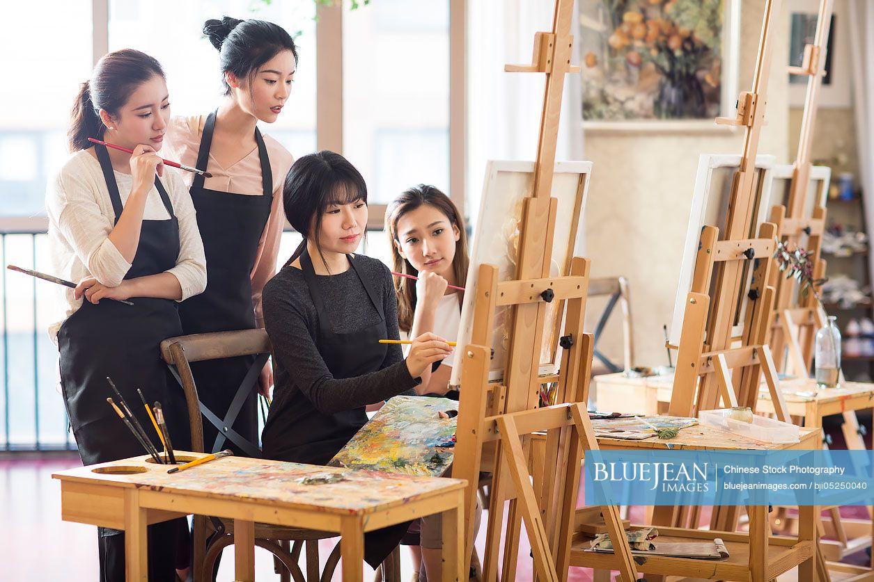 Chinese art teacher with young women in studio