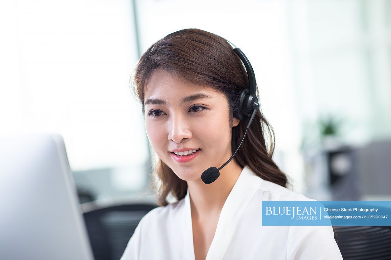 Young Chinese woman working in call center
