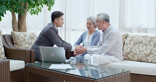 Happy senior Chinese couple talking with financial advisor at home,4K
