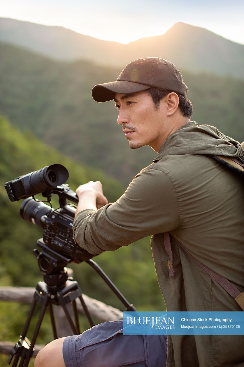 Chinese photographer taking photos outdoors