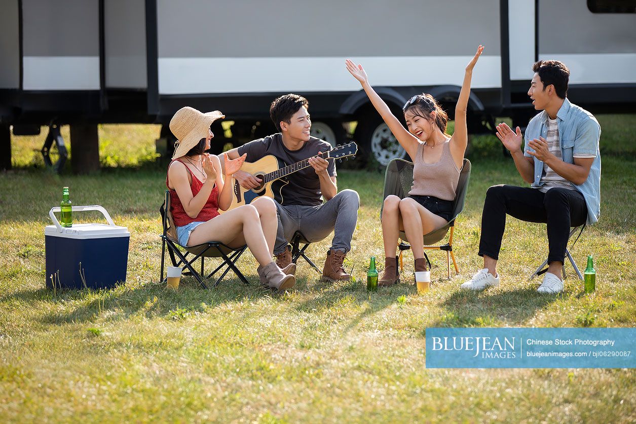 Happy young Chinese friends having fun outdoors