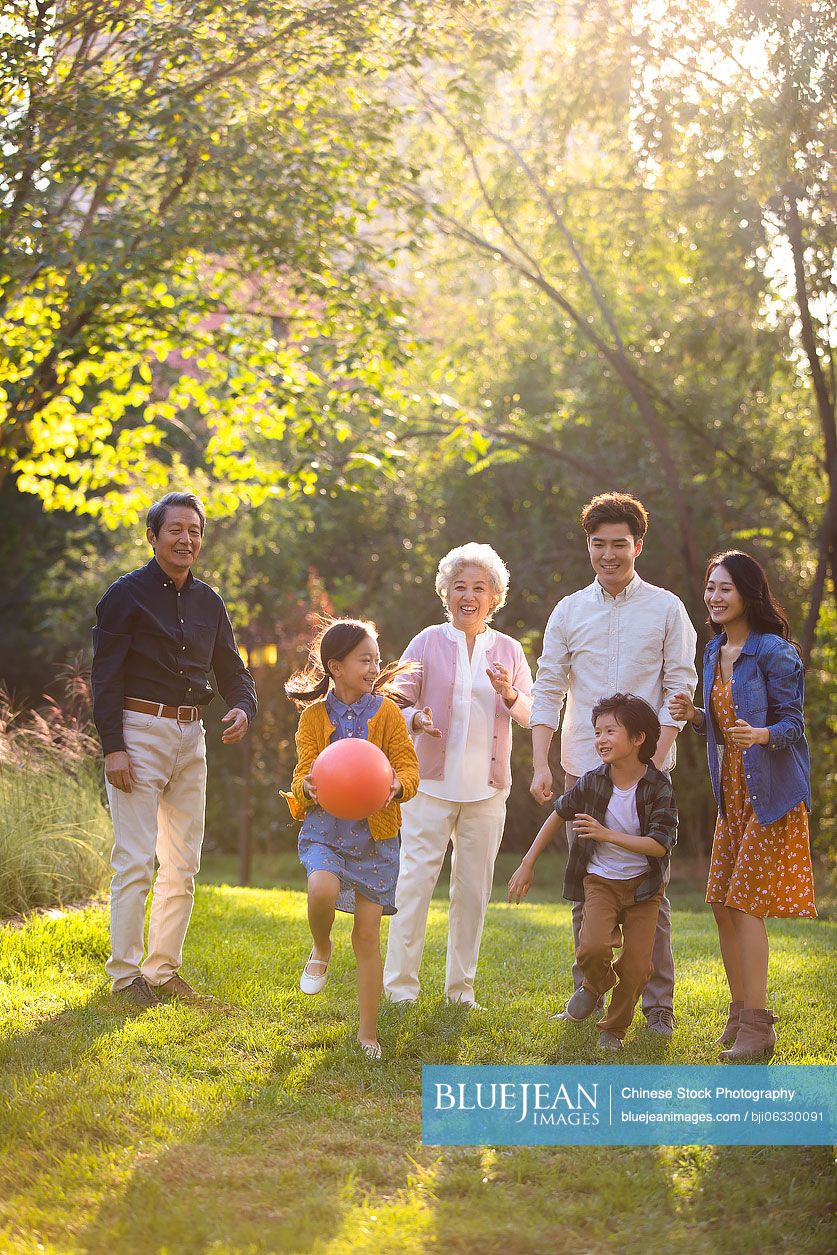 Happy Chinese family having fun in park