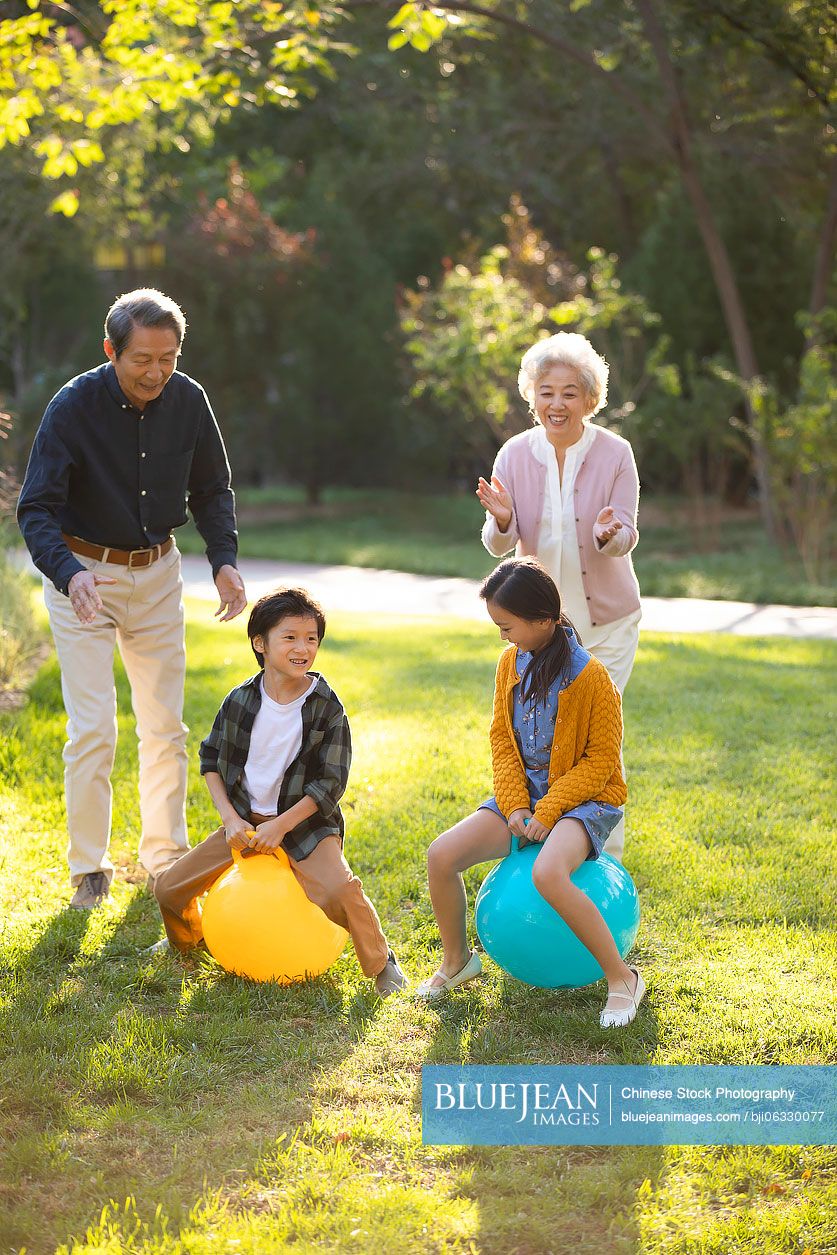Happy Chinese family having fun in park