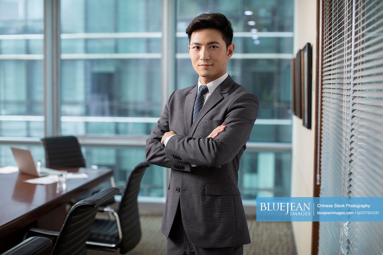 Confident Chinese businessman in meeting room