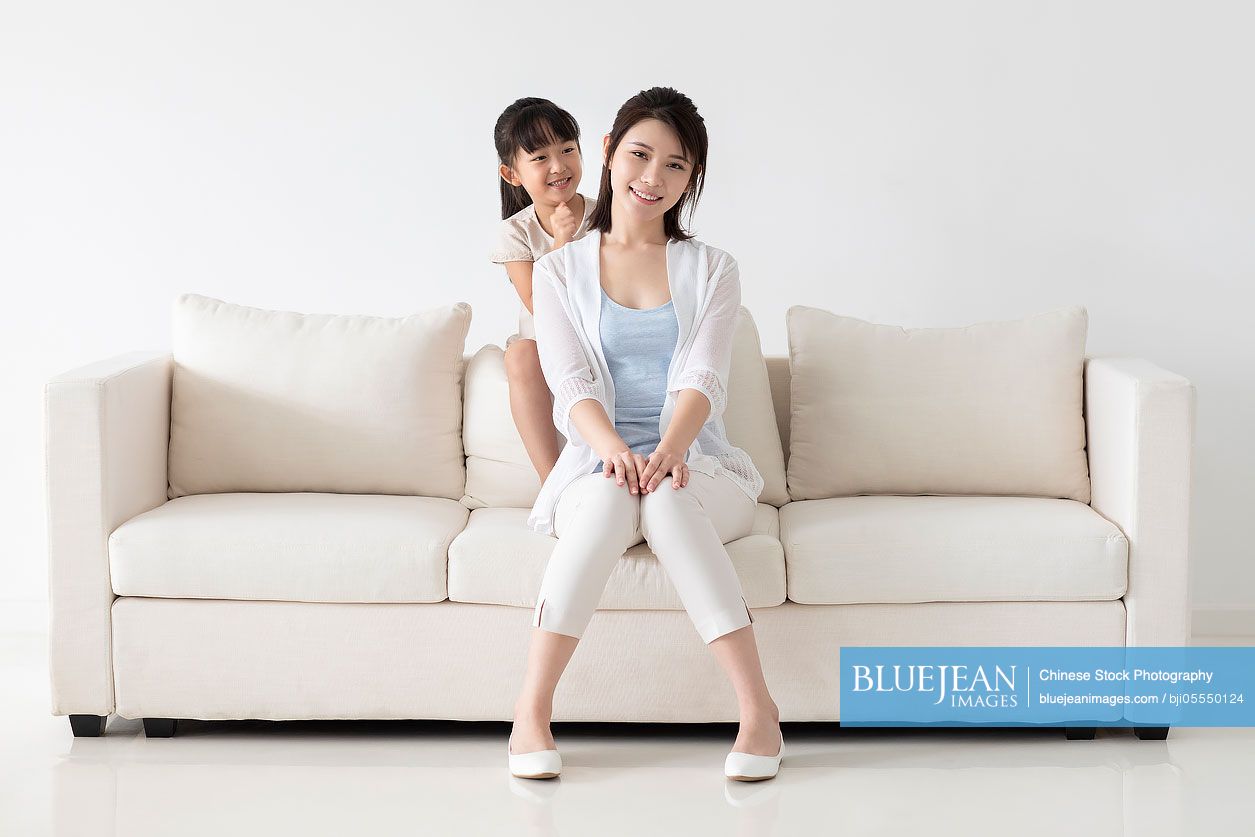 Chinese daughter massaging mother's shoulders