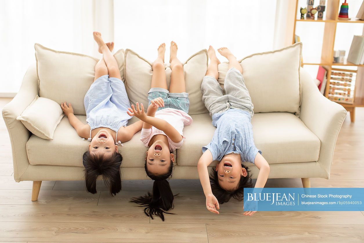 Cute Chinese children playing in living room