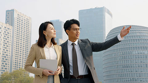 Confident Chinese business people talking outdoors