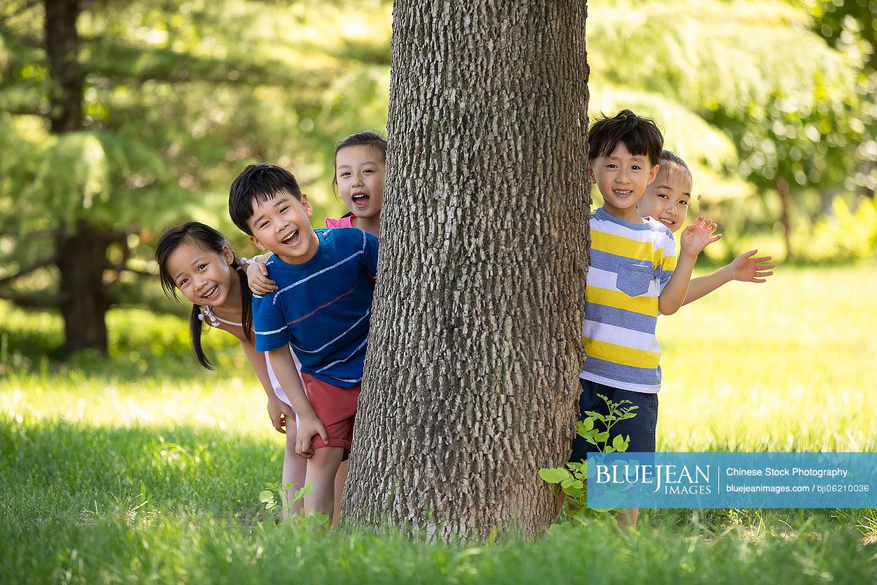 Happy Chinese children playing on meadow