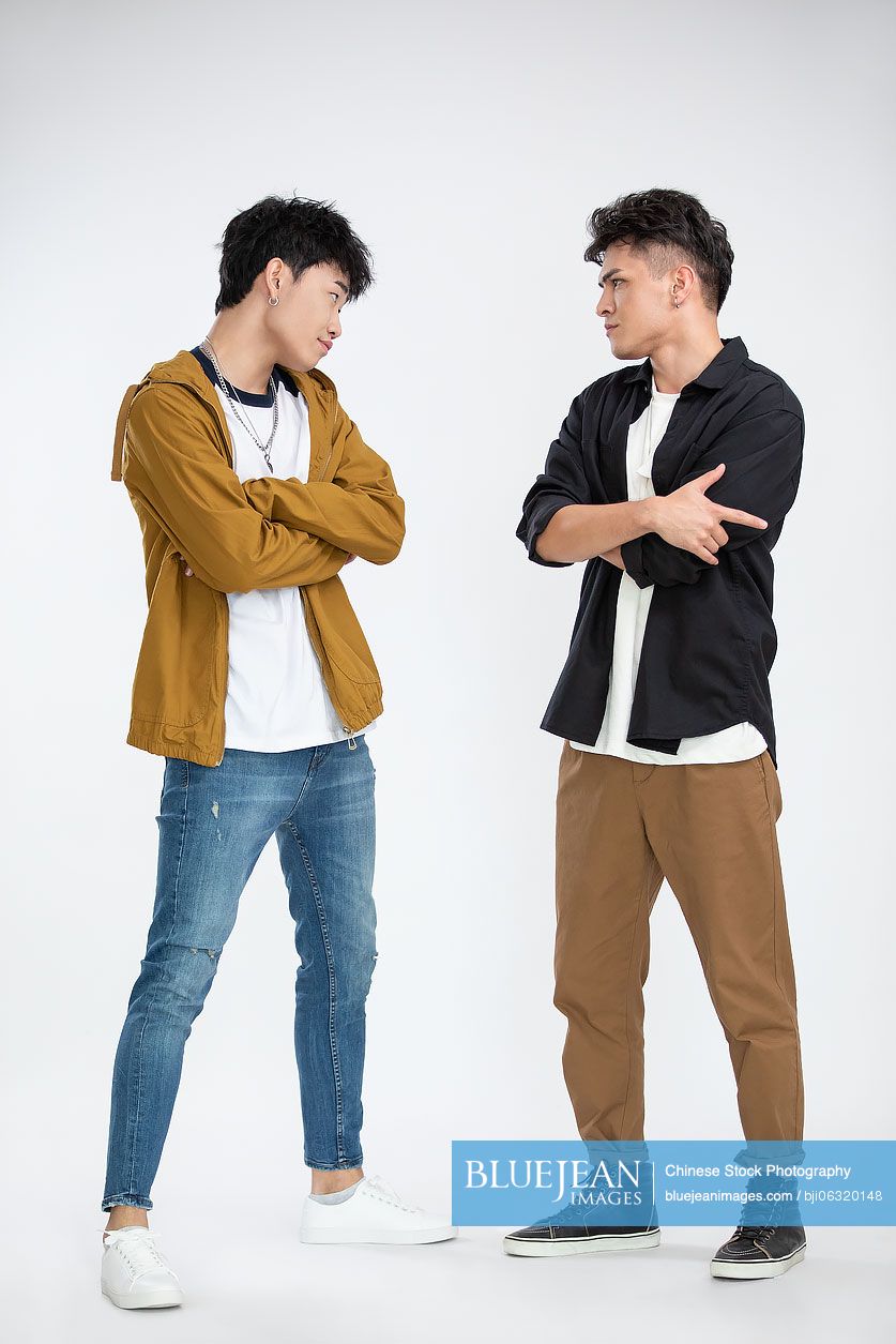 Young Chinese men standing face to face