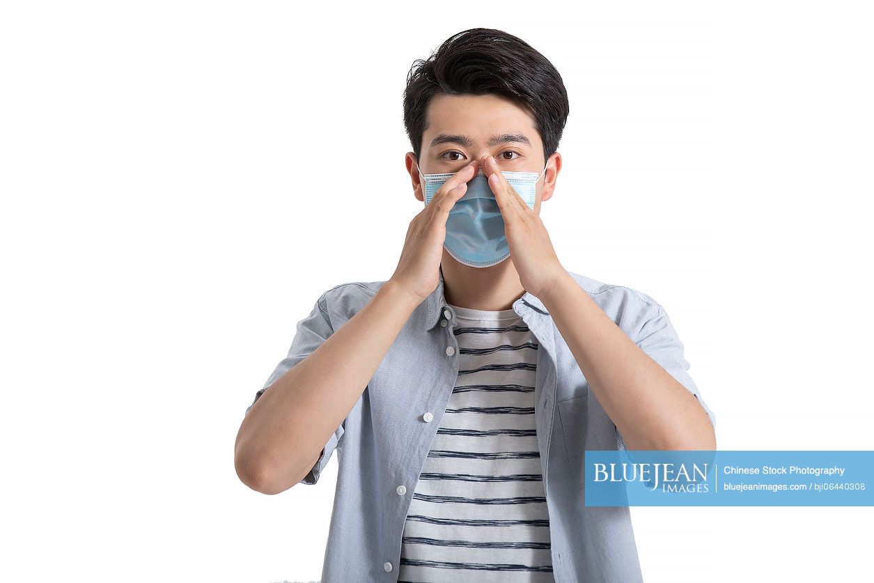 Young Chinese man wearing surgical mask