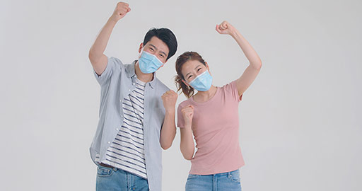 Young Chinese couple with surgical mask punching the air,4K