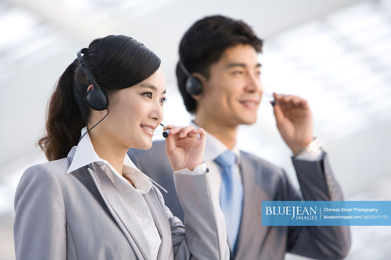 Chinese businessmen with headsets