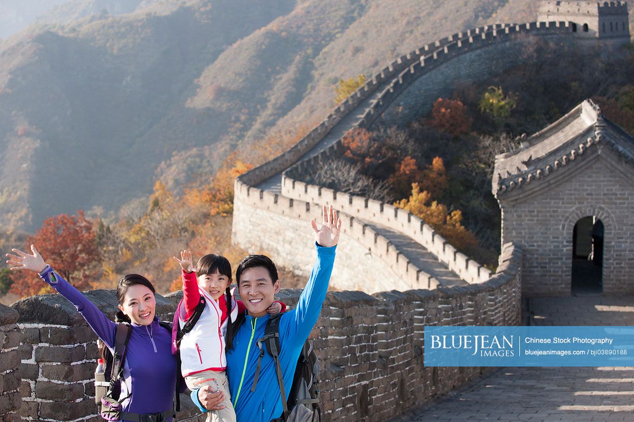 Young Chinese family enjoying autumn outing on Great Wall