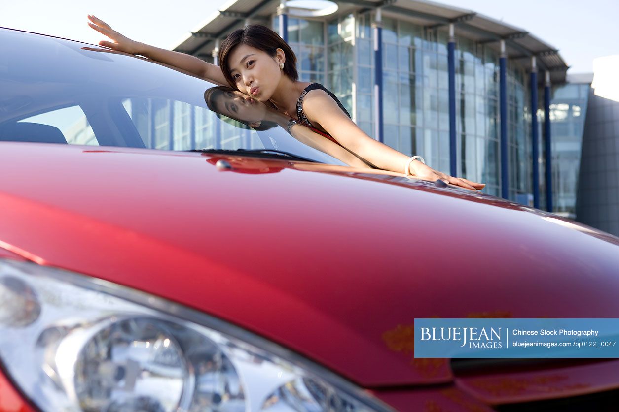 Chinese woman loving her new car