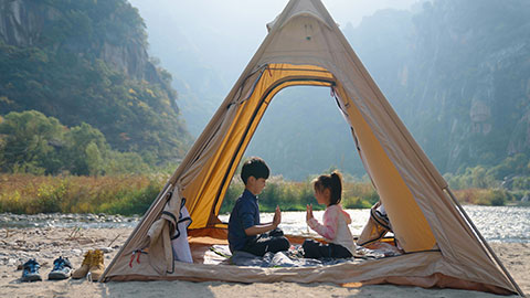 Cute Chinese Children relaxing in tent