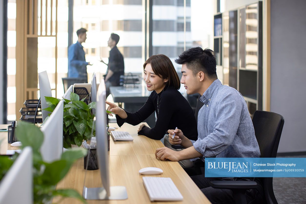 Chinese business people talking in office