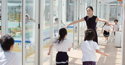 Chinese teacher and children in school hallway,4K