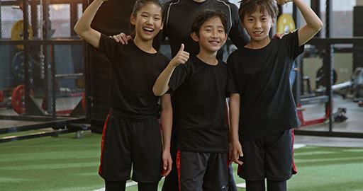 Cheerful Chinese children and their coach in gym,4K