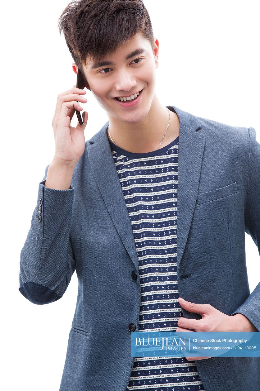 Young Chinese man talking on smart phone