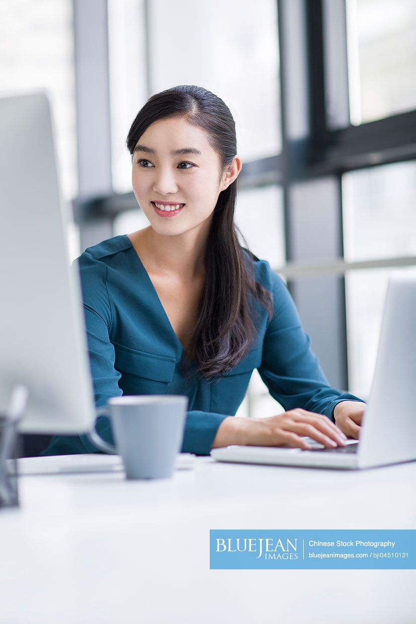 Young Chinese businesswoman working in office