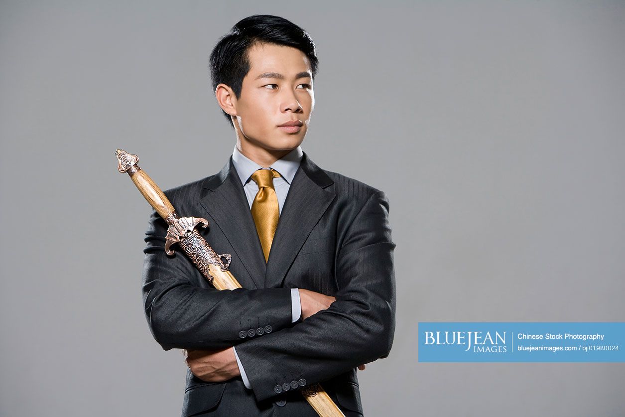 Chinese businessman holding a sword