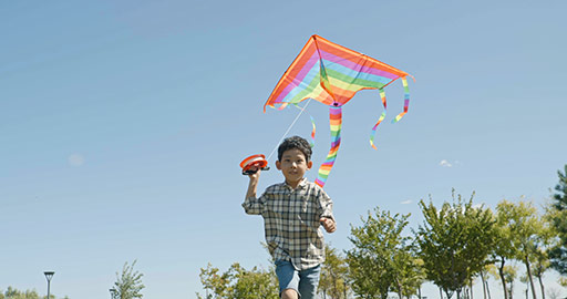 Happy Chinese boy running with kite on meadow,4K