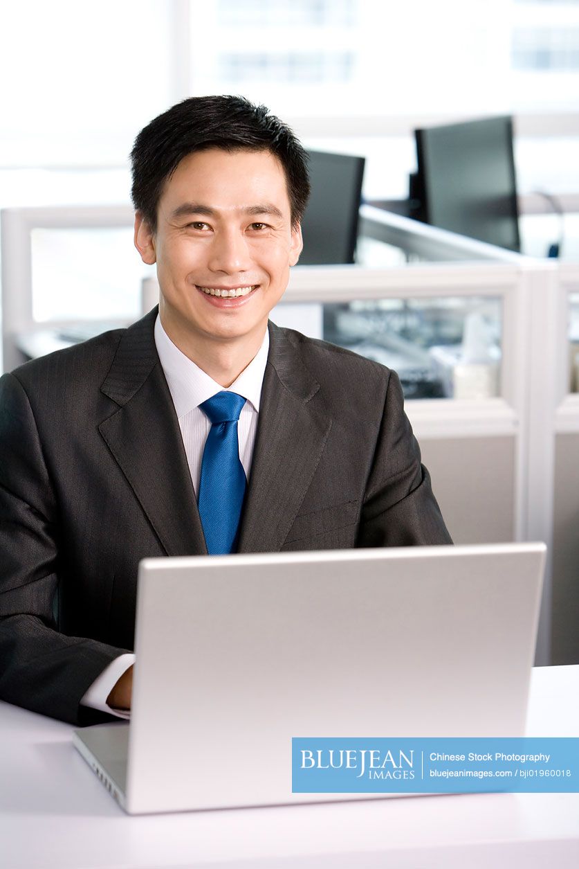 Chinese office worker at his desk