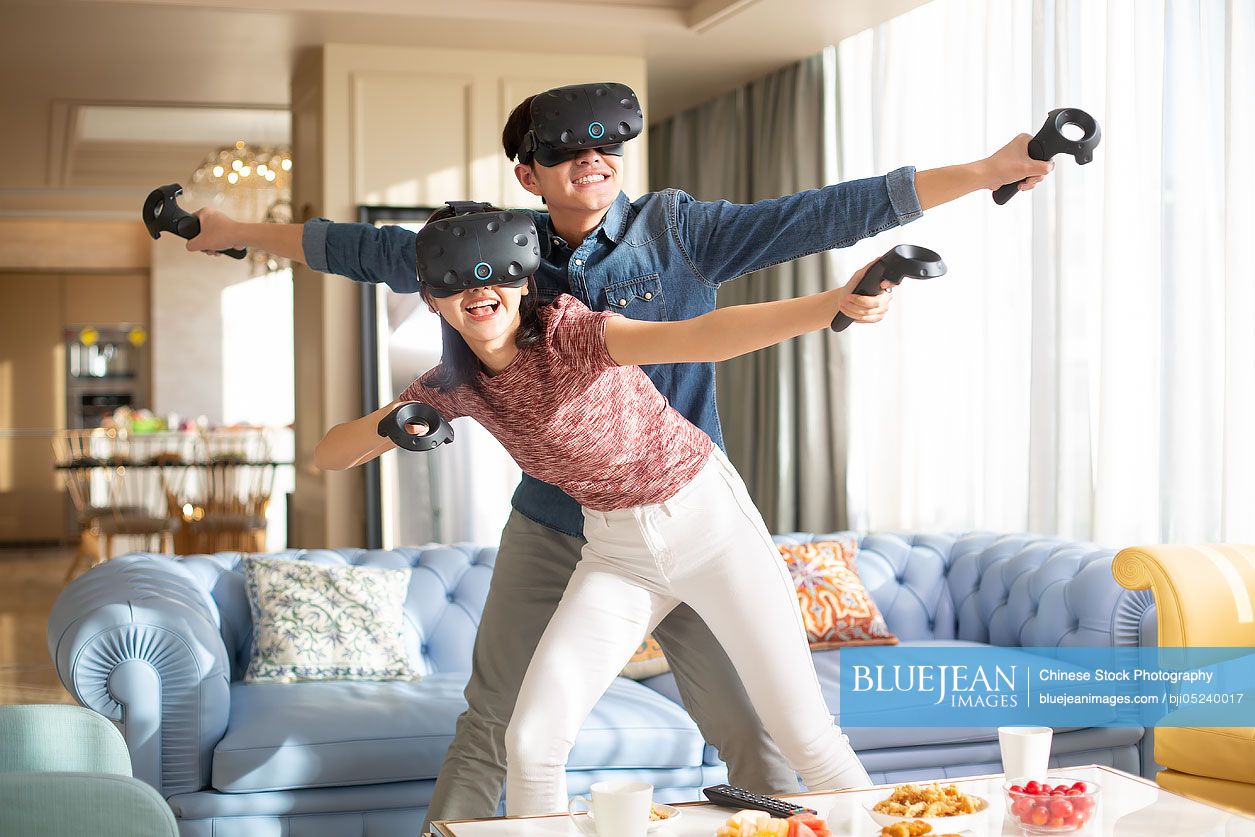 Young Chinese couple playing VR game