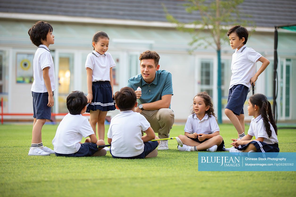 Foreign teacher teaching golf