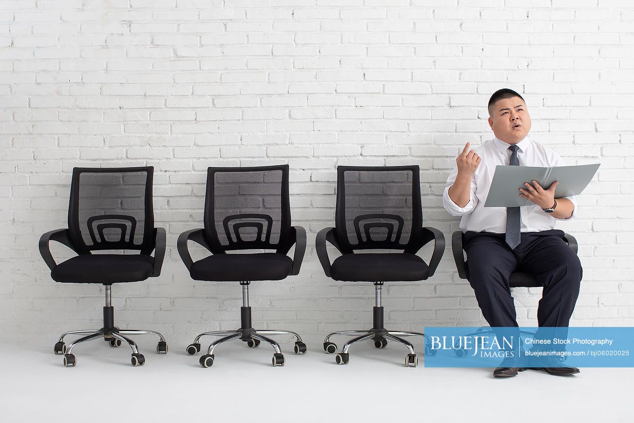 Young Chinese businessman preparing for job interview