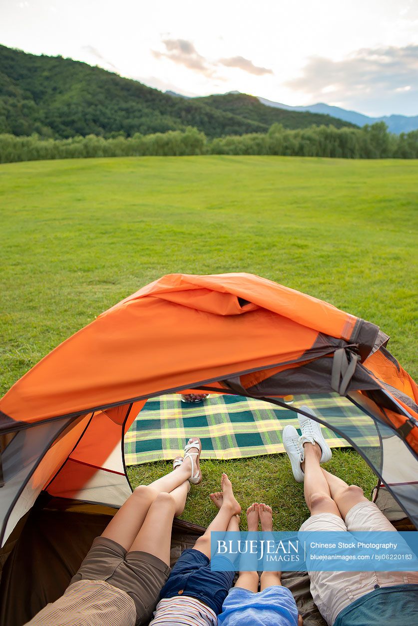 Young Chinese family camping outdoors