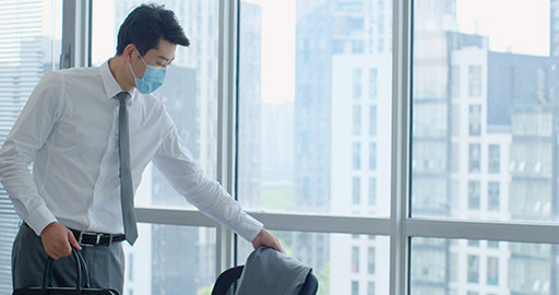 Young Chinese businessman with surgical mask coming to work,4K