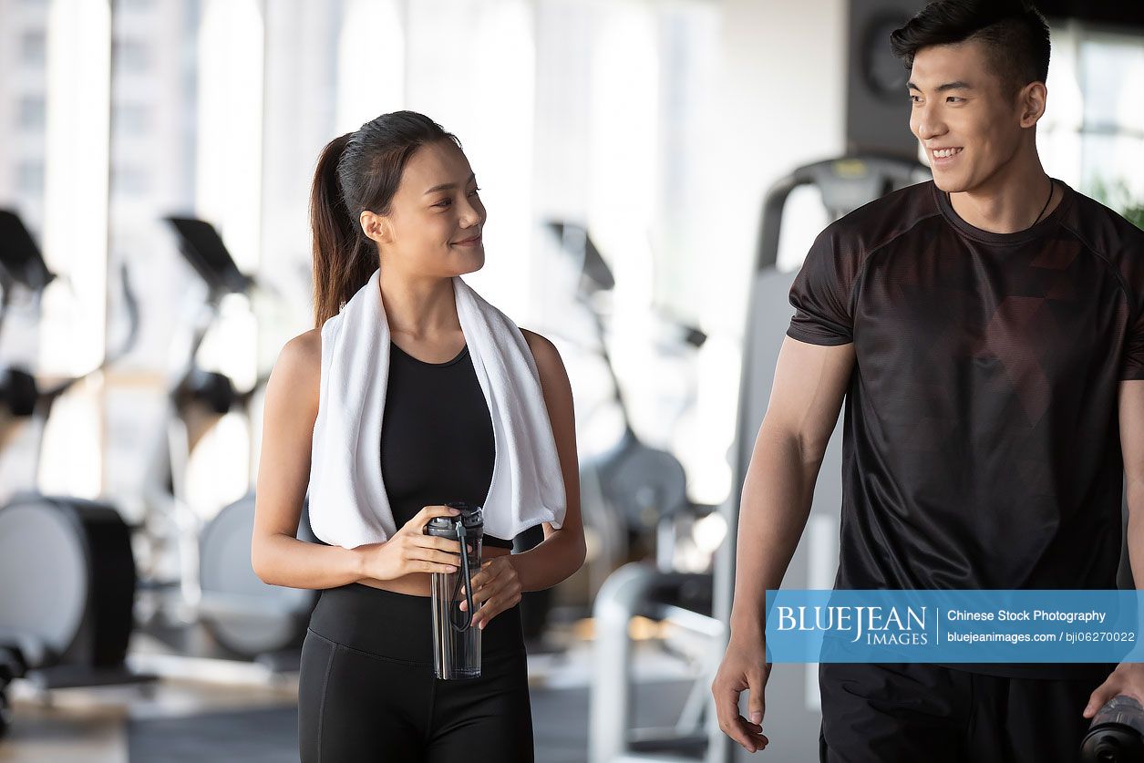 Young Chinese people taking a break from workout at gym