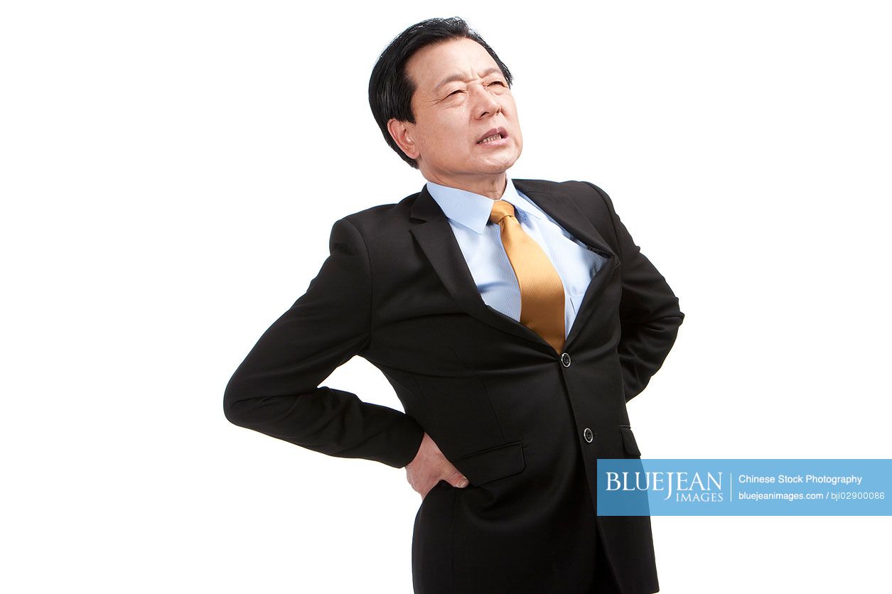 Senior Chinese businessman suffering from low back pain